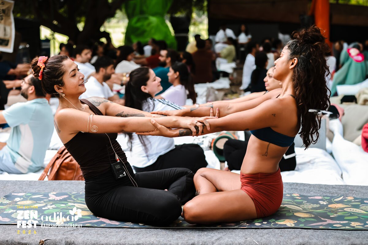 Partner stretching at Zen Fest outdoor yoga event
