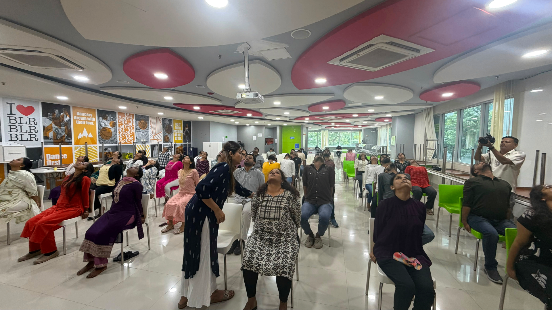 Seated corporate wellness session with chair-based stretches